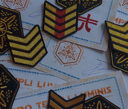 Rank insignia patches and Order certificates laid out on a table